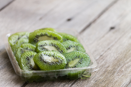 kiwi fresh fruit  in bowl on wood tableの写真素材