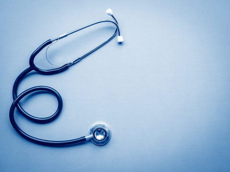 stethoscope on blue background copy space