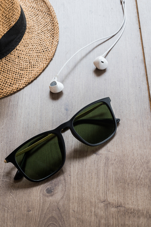 sunglasses and hat on wood tableの写真素材