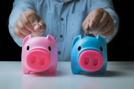 Man putting coin in piggy bank. Saving money conceptの写真素材