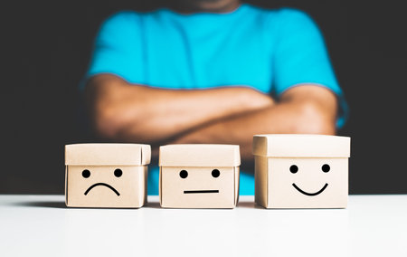 Thinking man chooses packaging with different emotion smiley face on brown box.copy space