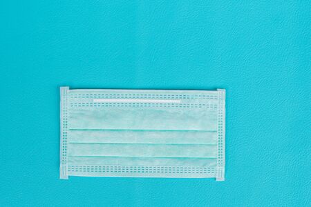 Surgical mask to cover the mouth and nose for prevention of the flu and the Coronavirus, covid-19. Health care and Protection concept.Top viewの写真素材