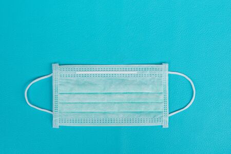 Surgical mask to cover the mouth and nose for prevention of the flu and the Coronavirus, covid-19. Health care and Protection concept.Top viewの写真素材