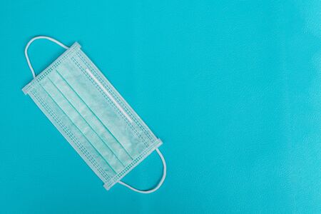 Surgical mask to cover the mouth and nose for prevention of the flu and the Coronavirus, covid-19. Health care and Protection concept.Top viewの写真素材