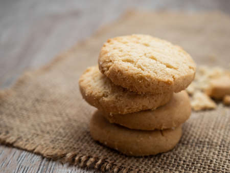 Stacked homemade biscuit sweet cookie on rustic wooden tableの写真素材