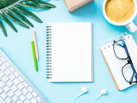 Top view workspace office business desktop with office accessories on blue backgroundの写真素材