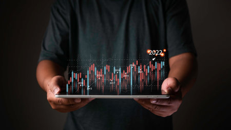 Planning and strategy, Stock market, Business growth, progress or success concept. Businessman or trader is showing a growing virtual hologram stock on the tablet computer, invest in tradingの写真素材