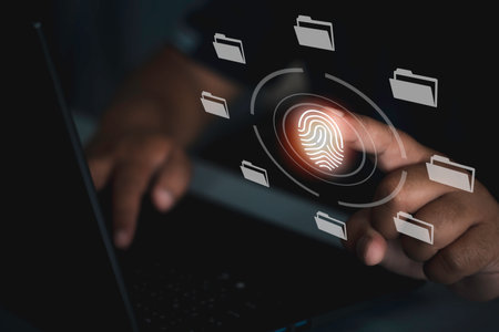 Businessman using laptop computer protecting business by Fingerprint scanning and biometric authentication, processing of biometric for access personal dataの写真素材
