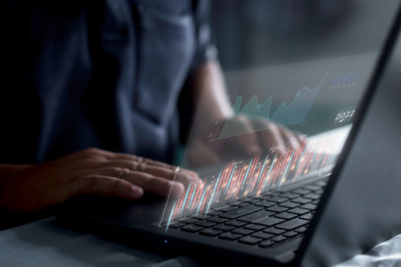 Businessman using laptop planning and strategy, Stock market, Business growthor trader is showing a growing virtual hologram stock, invest in tradingの写真素材