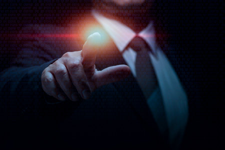 The businessman uses his index finger to direct the desired work. Concepts about controlling success in businessの写真素材