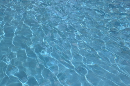 blue water reflecting in the poolの写真素材