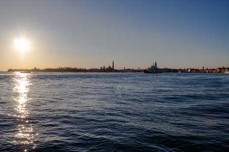 The sun sets over the Venetian lagoon and the distant San Giorgio Maggiore islandの写真素材