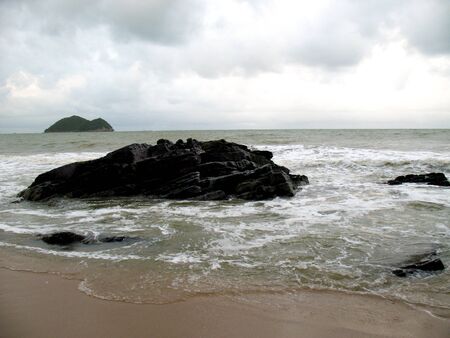 Stone in sea with waveの写真素材