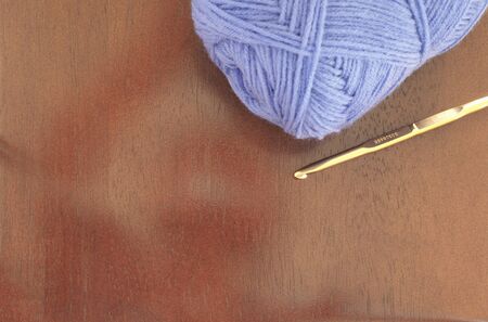 yarn balls and knitting needles on wooden backgroundの写真素材