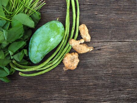 Fresh organic vegetables on wooden background, top viewの写真素材