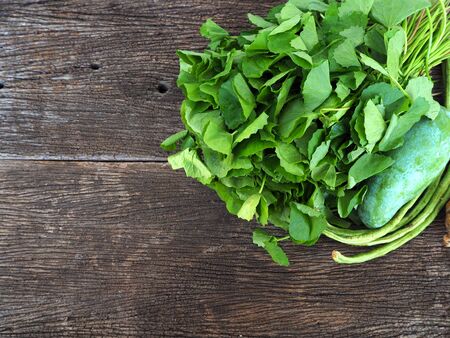 Fresh organic vegetables on wooden background, top viewの写真素材