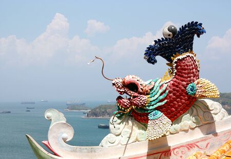 fish sculpture in Temple roof, Thailandの写真素材