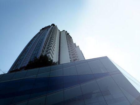 Modern Contemporary Glass Office Building Against sky Backgroundの写真素材