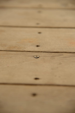 Line of screw holes in old and weathered planks of wood   Only one screw remaining の写真素材