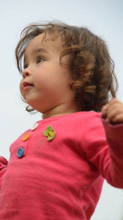 Little girl staring into distance with curious facial expression の写真素材