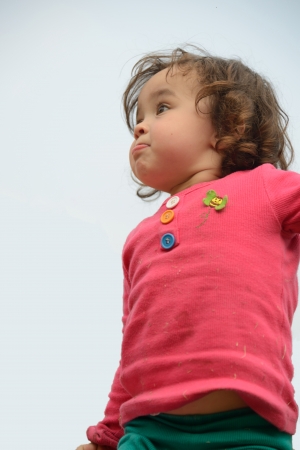 Little girl staring into distance with determined facial expression の写真素材