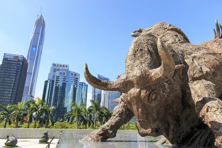 Shenzhen, China - August 19,2015: Stock market building in Shenzhen, one of the three stock markets in China, with the copper bull statue on foreground. The others two Stock Markets of China are in Hong Kong and Shanghai. Shenzhen, China - August 19,2015: Stock market building in Shenzhen, one of the three stock markets in China, with the copper bull statue on foreground. The others two Stock Markets of China are in Hong Kong and Shanghai.