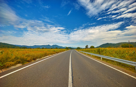 Road and mountain horizon landscape and beautiful sky in Romania.