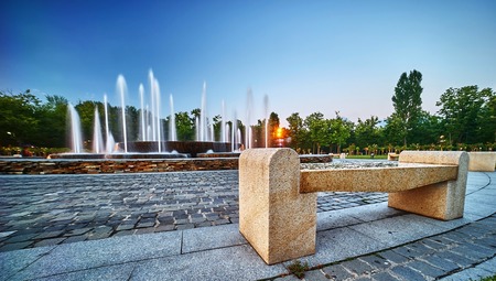 Bench and artesian fountain in Titan Park, Bucharestの写真素材