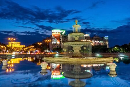 BUCHAREST, RO, JUL 05 2015: Unirii Fountain Reflection Sunsetのeditorial素材