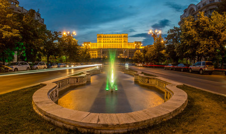 BUCHAREST, RO, MAY 2015: Unirii Boulevard and Fountains with Parliament Palace (Casa Poporului) in...