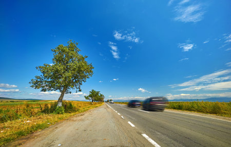 Traffic on country road landscape.