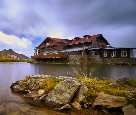 BALEA LAC, RO, AUG 2015: Chalet and Frozen Lake Landscape in Fagaras Mountains.のeditorial素材