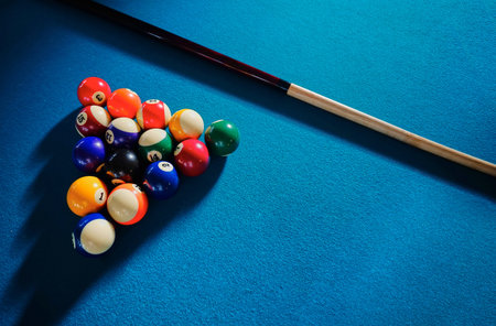 Billiard Balls and Cue on Blue Backgroundの写真素材