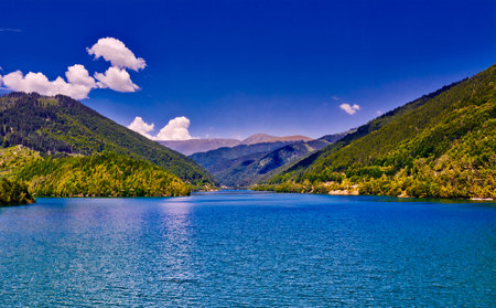 Mountain landscape with lake and blue sky in the summer.