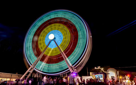 Ferris wheel in motion at night.の写真素材
