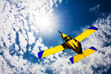 Airplane flying towards the sun.の写真素材