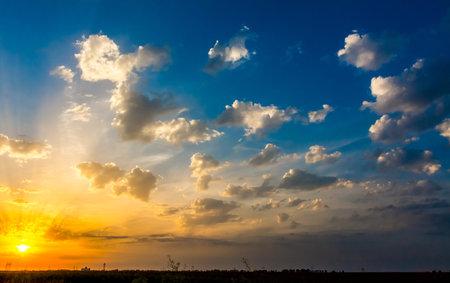 Orange sunset with blue sky and white clouds.の写真素材