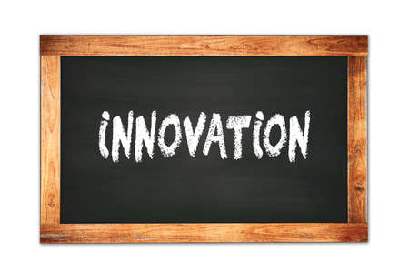INNOVATION text written on black wooden frame school blackboard.の写真素材