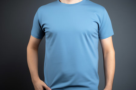 Man in blank blue t-shirt on grey background, closeupの素材