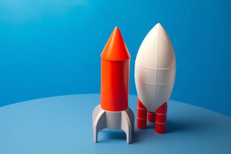 3d rendering of red and white rocket on blue background with copy spaceの素材