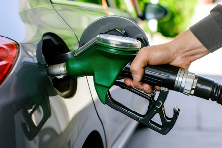 Photo a person pumping gasoline fuel in car at gas stationの素材