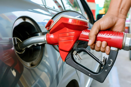 Photo a person pumping gasoline fuel in car at gas stationの素材