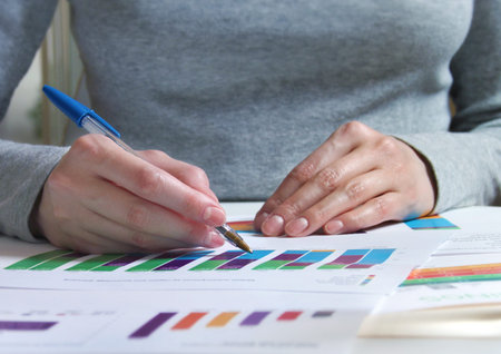 A girl reviewing documents with charts and graphs