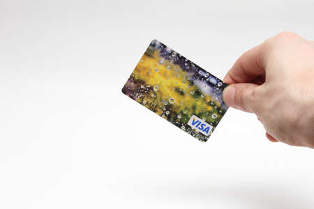 Credit card in his right hand on the isolated backgroundのeditorial素材