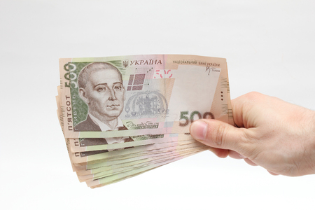 Ukrainian hryvnia large bills in his right handの写真素材