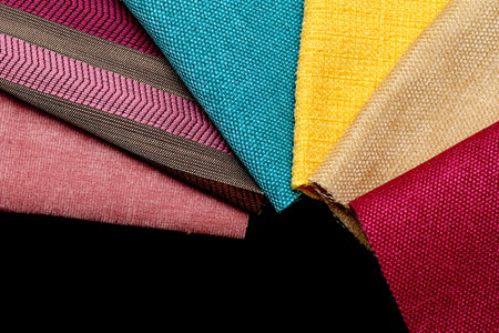 pieces of cloth of different colors on a black table