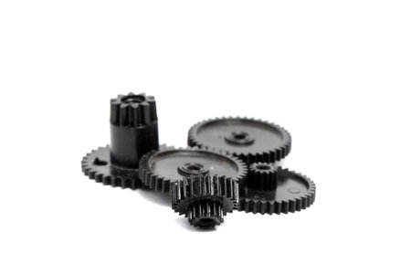 Plastic gears of different sizes on a white backgroundの写真素材