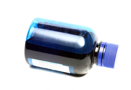 bottle with blue paint isolated on white backgroundの写真素材