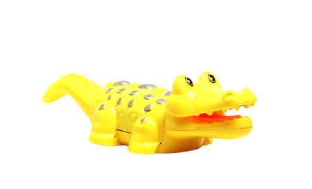 yellow crocodile toy on a white backgroundの写真素材