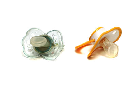 two dirty blue pacifier on a white backgroundの写真素材
